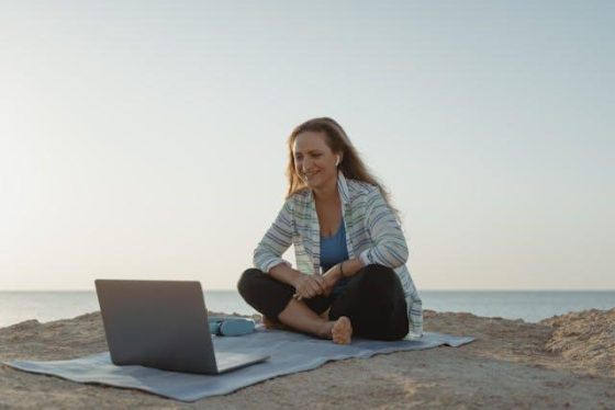 woman working on her laptop on the beach 